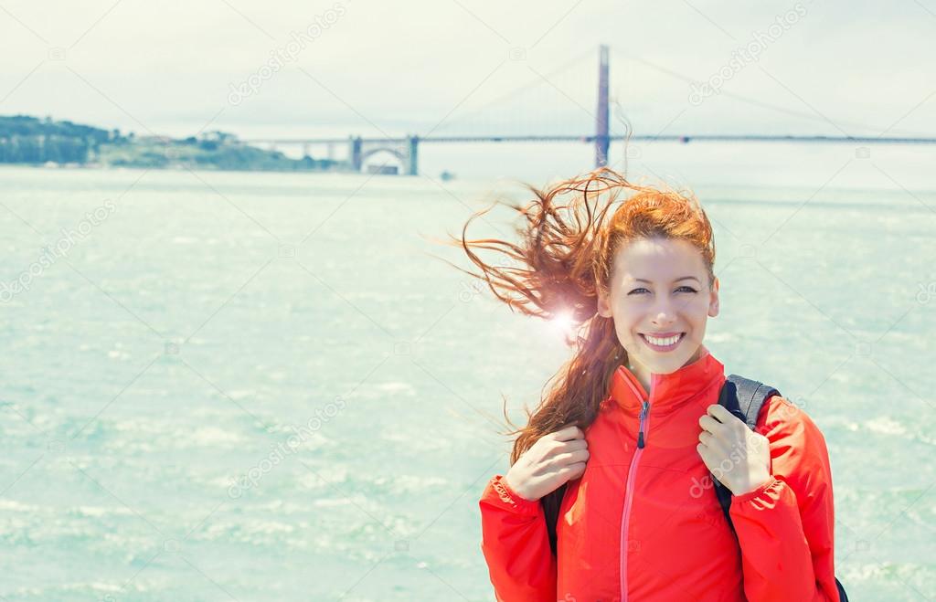 Happy woman tourist in San Francisco with Golden Gate Bridge bac