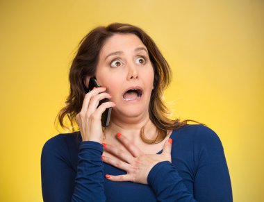 Woman receiving shocking news on a phone clipart