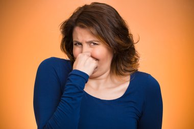 Woman pinches her nose, bad smell  clipart