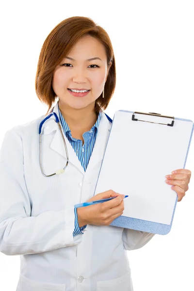 Doctor holding blank clipboard pointing with pen, offering to sign — Stock Photo, Image