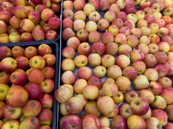 Fresh ripe red apples for sale on display at the fruits section in a supermarket.