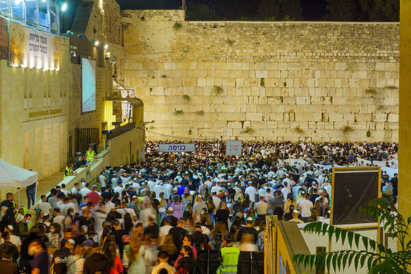 Jerusalem, Israel - August 31, 2021: Crowd of Jewish prayers attend a mass Selichot, Jewish penitential prays, at the Western Wall, Old City of Jerusalem, Israel