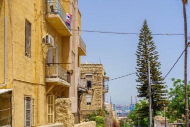 Haifa, Israel - May 13, 2022: View of old buildings, and the harbor, in Hadar HaCarmel Neighborhood, Haifa, Israel