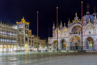 Venice, Italy - February 28, 2022: Night scene of St. Marks Square, with locals and visitors, in Venice, Veneto, Northern Italy