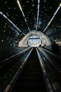 Exit to the escalator in the subway. Bottom-up view.