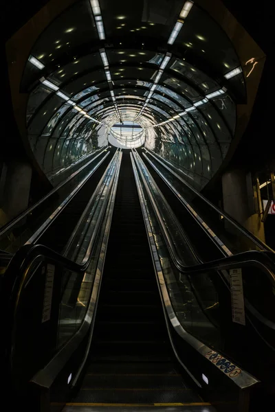 Exit to the escalator in the subway. Bottom-up view.