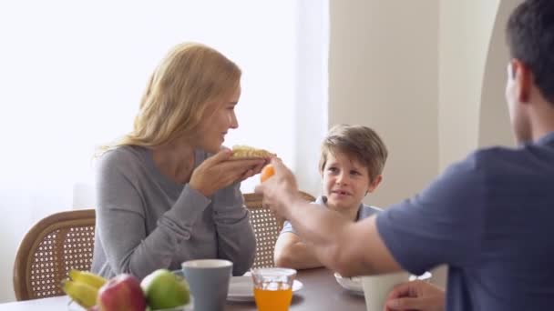 幸せな白人の父は 自宅で朝食を共にしながら彼の愛らしい子供にサービスを提供しています 健康的な食べ物 幸せな家族の概念 — ストック動画