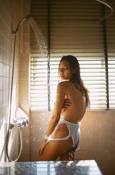 Tutkulu, güzel, Asyalı bir kadının banyo yaparken kameraya bakışının şehvetli portresi. Rahatlatıcı, dinlenme zamanı, güzellik, kişisel bakım, cilt hijyeni kavramı.