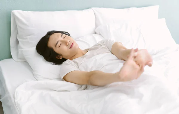 Happy Asian Man Pajamas White Sheet Pillow Stretching Wake Morning — 스톡 사진