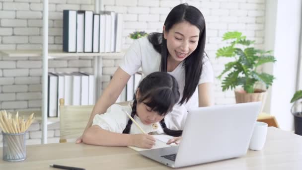 Portrait Young Asian Mother Helping Teach Her Daughter Homework While — Stock Video