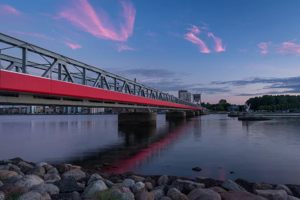 The Cultural Bridge - a train and pedestrian bridge in Aalborg, Denmark, during a colorful sunset