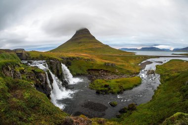 Kirkjufellsfoss waterfall and Kirkjufell mountain clipart