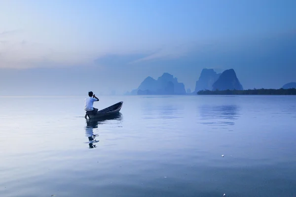 Man in fishing boat Stock Photo