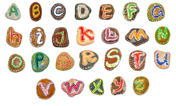 Алфавит, написанный на камнях - все буквы — стоковое фото