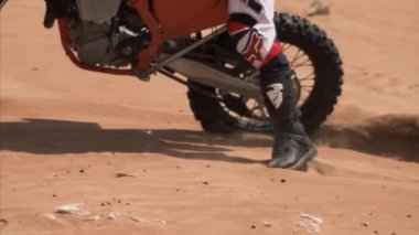 Yavaş çekimde kum üzerinde bisiklet sürüş görüntüsü. Toz, kum taneleri, Dubai, BAE, Boş Çeyrek çöllük, kamera görüntüleri.