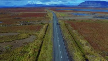 Aerial vertical panoramic view of road with car and Icelands nature