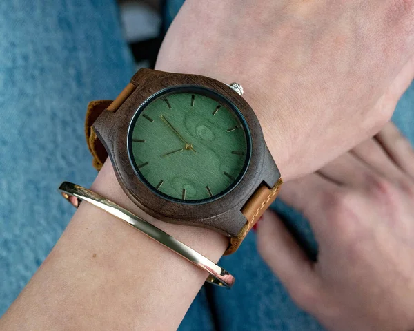 Retro wooden wrist watch on hand