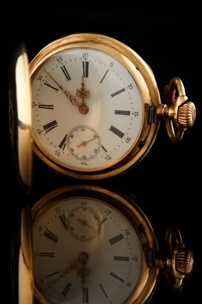 Old pocket watch on dark glass background — Stock Photo, Image