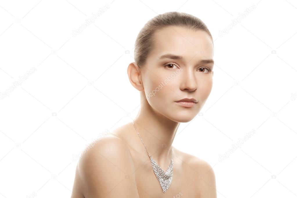 Beautiful young woman with a natural make-up and luxury necklace