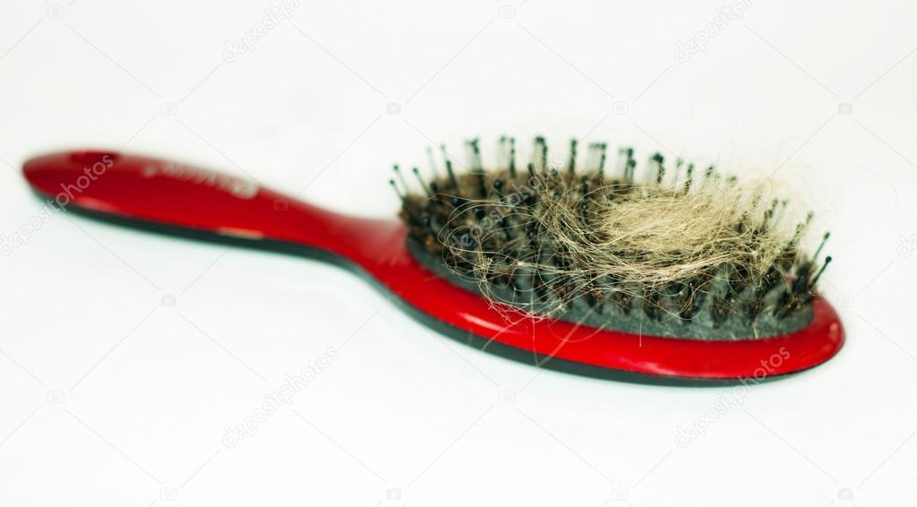 Red hair comb with torn