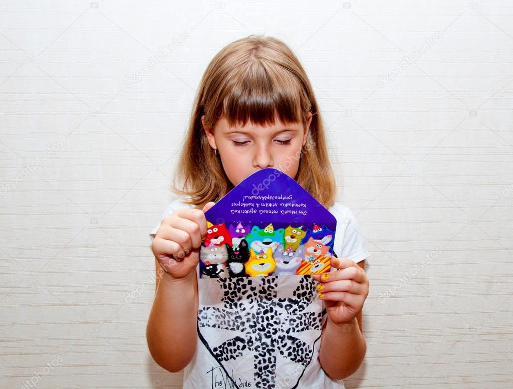 Girl reads greeting card
