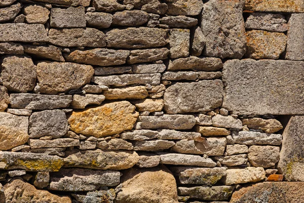 Old stoned wall with bird flying in the bottom right side — Stock Photo, Image
