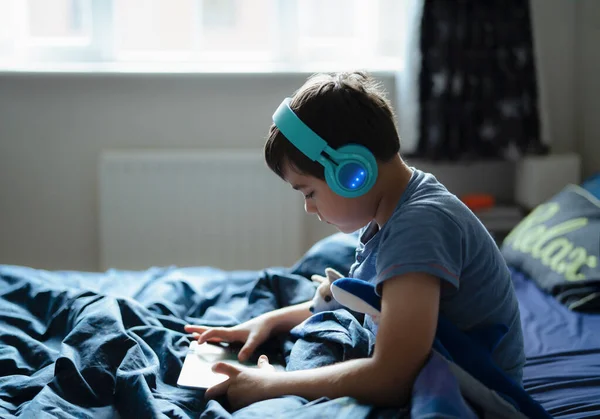 Happy Boy Wear Wireless Headphone Listening Music While Sitting Bed — Stock Photo, Image