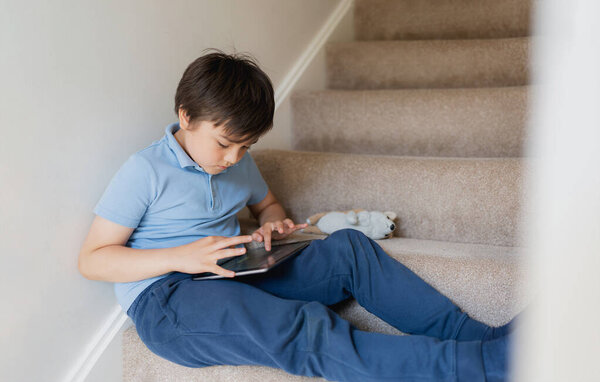 Kid Using Tablet Playing Game Internet Homeschooling Kid Doing Homework Stock Image