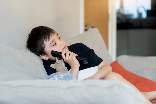 Kid Sitting Sofa Watching Boy Holding Remote Control Looking Deep — Stock Fotó