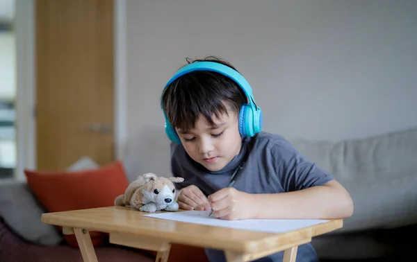 Happy Kid Wearing Some Headphones Listening Music While Drawing Sketching — Stock Photo, Image