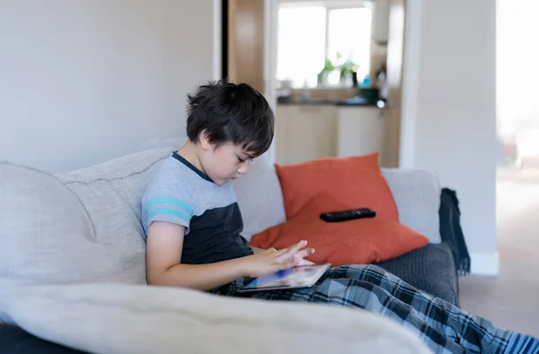 Portrait Kid Playing Game Tablet Sitting Sofa Young Boy Reading — Stok Foto