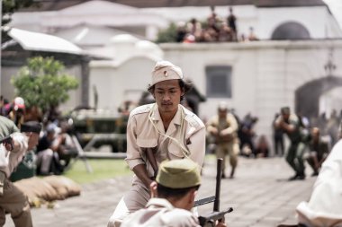 Teatral savaş genel taarruzu, Hollanda sömürge döneminde savaş üniformaları ve silahları kullanılarak gerçekleştirildi. Birbirlerini vuruyorlar. : Yogyakarta, Endonezya - 01 Mart 2022