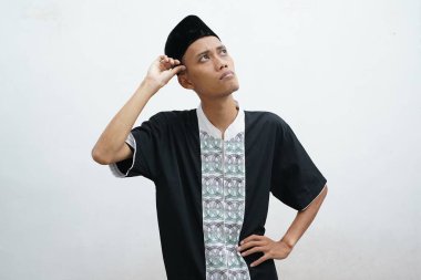 Asyalı Müslüman adam jestler yapıyor, beyaz arka planda fikir arıyor.