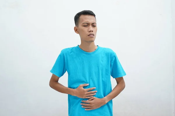 Homem Asiático Vestindo Camiseta Azul Coloca Mão Sobre Estômago Devido — Fotografia de Stock