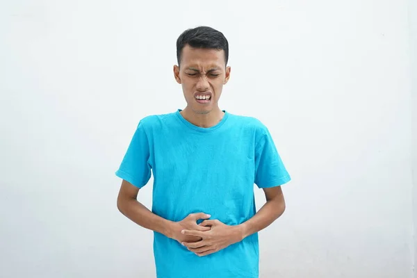 Asian Man Wearing Blue Shirt Puts Hand Stomach Due Nausea — стокове фото