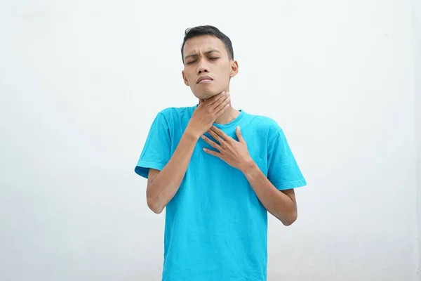 Young Asian Man Wearing Blue Shirt Has Sore Throat Touches — стоковое фото