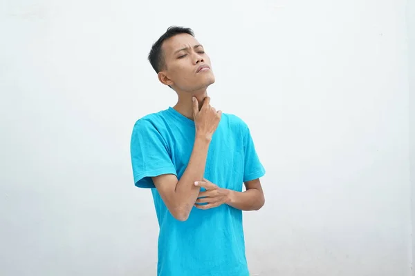 Young Asian Man Wearing Blue Shirt Has Sore Throat Touches — стоковое фото