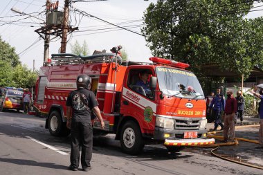 fire engines are on standby and trying to extinguish the fire at the furniture warehouse fire site. : Yogyakarta, Indonesia - 12 May 2022