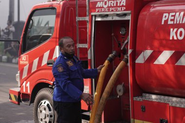 İtfaiyeciler beklemede ve mobilya deposundaki yangını söndürmeye çalışıyorlar. : Yogyakarta, Endonezya - 12 Mayıs 2022