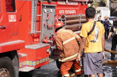 Firefighters on standby and trying to extinguish the fire at the furniture warehouse fire site. : Yogyakarta, Indonesia - 12 May 2022