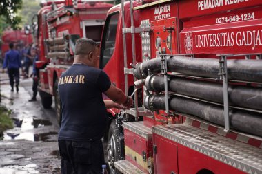 Firefighters on standby and trying to extinguish the fire at the furniture warehouse fire site. : Yogyakarta, Indonesia - 12 May 2022