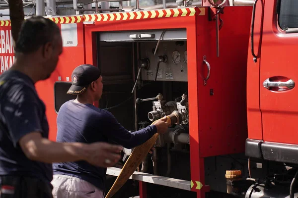 İtfaiyeciler beklemede ve mobilya deposundaki yangını söndürmeye çalışıyorlar. : Yogyakarta, Endonezya - 12 Mayıs 2022