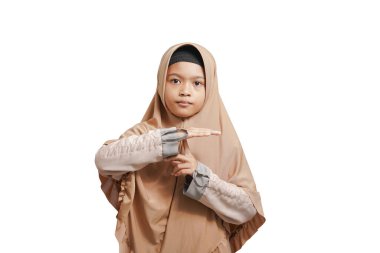 beautiful asian muslim child with hand showing stop sign, silent sign, don't talk with hand, don't make a signature, isolated on white background