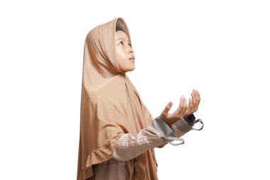 girl wearing a hijab, wearing a brown Muslim dress praying on a white background