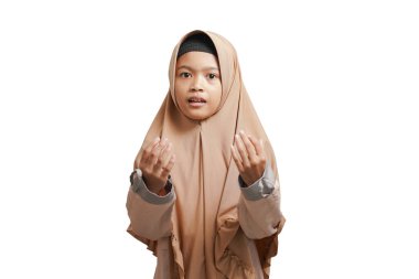 girl wearing a hijab, wearing a brown Muslim dress praying on a white background