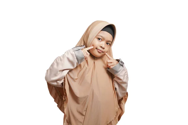 Smiling Asian Muslim Girl Holding Two Index Fingers Her Cheeks — Stockfoto