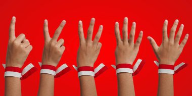 A collection of fingers of the numbers one, two, three, four, five and the red and white ribbon of the Indonesian flag, the concept of independence.