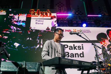 Keyboardist musicians from Paksi band, a modern keroncong music group from Yogyakarta, performed energetically to entertain the audience. : Yogyakarta, Indonesia - 07 September 2022