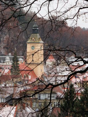 Medieval church tower over Braov's Old Town. Beautiful winter day in Romania. 