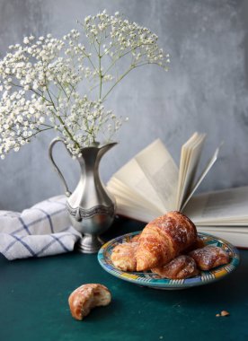 Masada güzel bir kahvaltı. Taze pişmiş kruvasanlar yakın plan fotoğraf. Gıda hala hayat. 